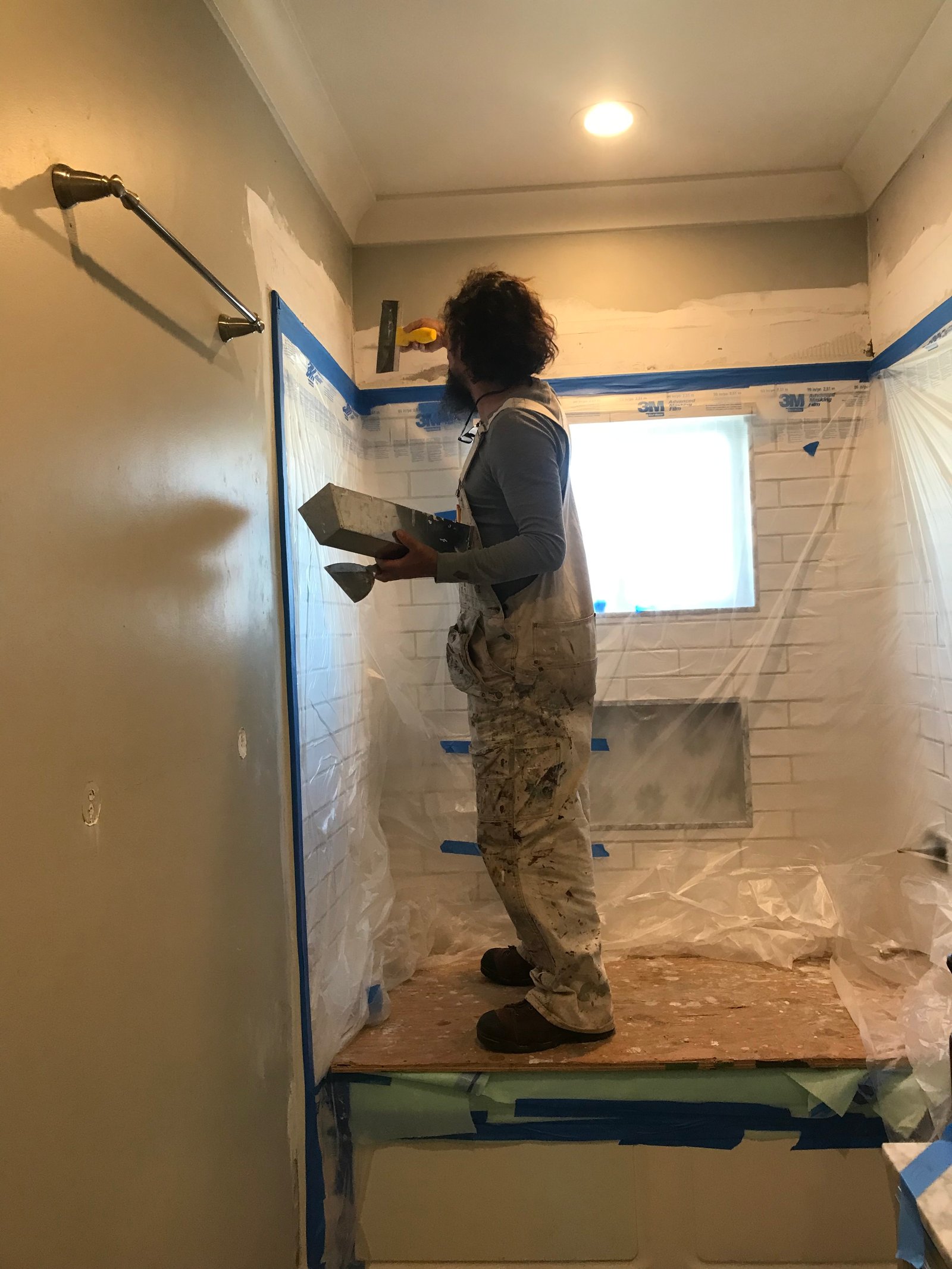 Installer aligning marble backsplash on a vanity