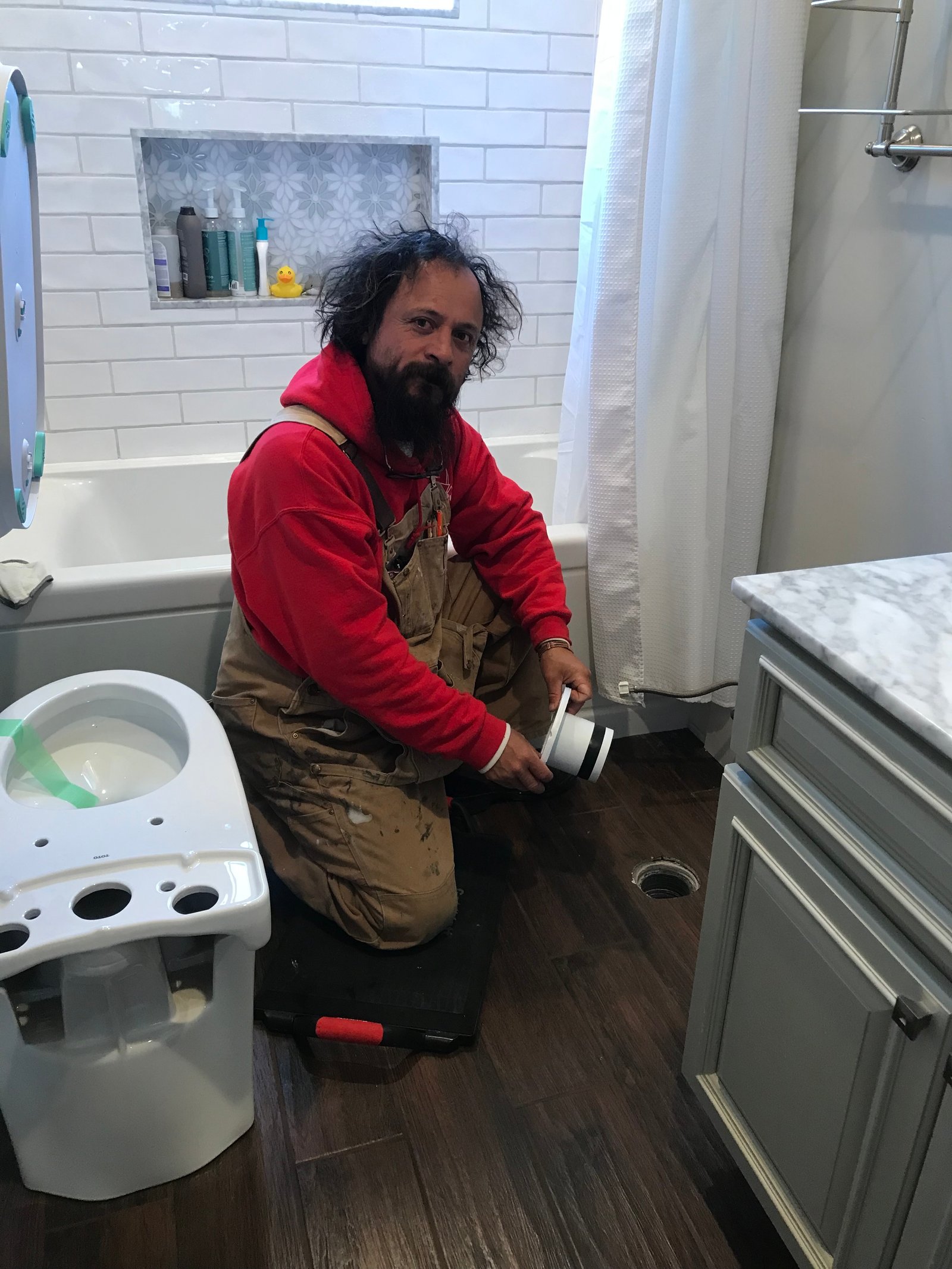 Finished bathroom with shower curtain and storage shelving