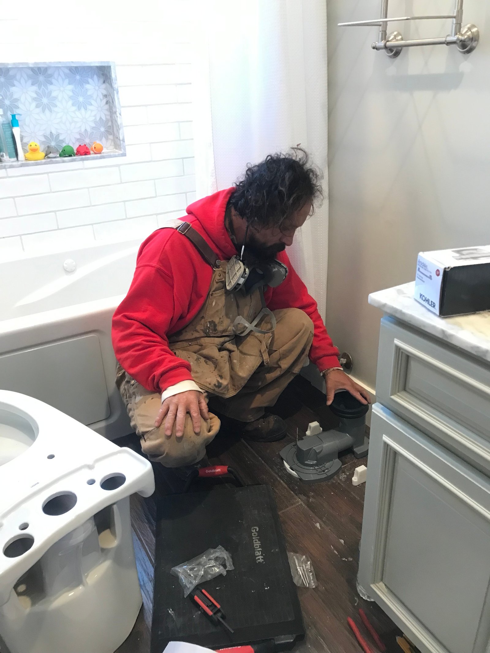 Installer prepping closet flange for toilet installation