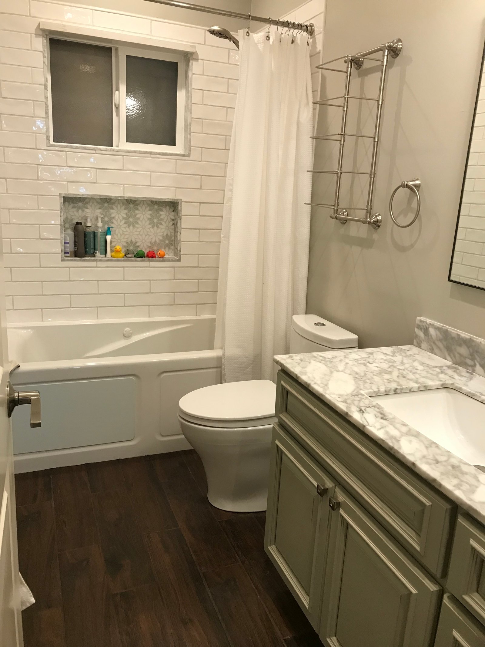 Freshly remodeled bathroom with tiled alcove and soaking tub
